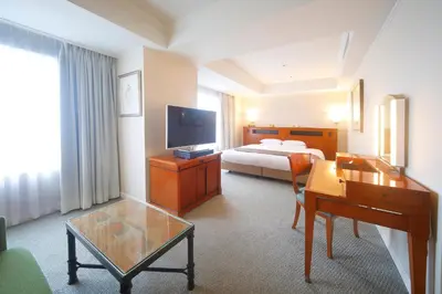 a hotel room with a bed and a television at Hotel East 21 Tokyo in Tokyo