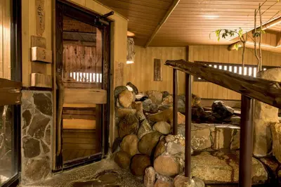 a room with a pile of logs in a room at the b suidobashi in Tokyo