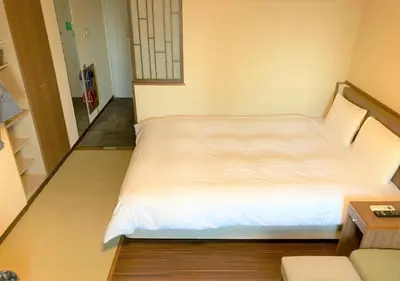 a bedroom with a white bed in a room at Dormy Inn EXPRESS Asakusa in Tokyo
