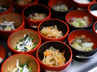 a group of small bowls filled with different types of food at Dormy Inn EXPRESS Asakusa in Tokyo