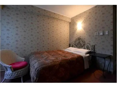 a bedroom with a bed and a desk and a chair at Sakura Fleur Aoyama in Tokyo