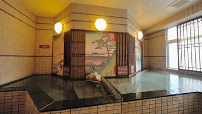 a large room with a wall with a painting on it at Dormy Inn Express Meguro Aobadai Hot Spring in Tokyo