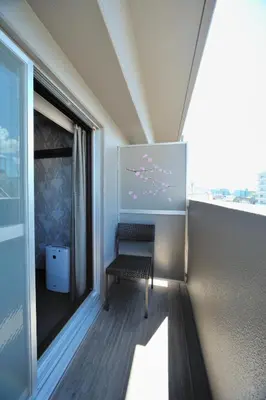 a balcony with a bench and a window at Dormy Inn Express Meguro Aobadai Hot Spring in Tokyo