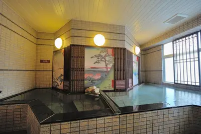 a large bathroom with a tile floor and a painting on the wall at Dormy Inn Express Meguro Aobadai Hot Spring in Tokyo