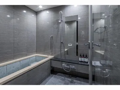 a bathroom with a tub and a glass shower at Randor Residence Tokyo Suites in Tokyo
