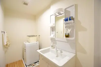 a white bathroom with a sink and a refrigerator at Randor Residence Tokyo Suites in Tokyo