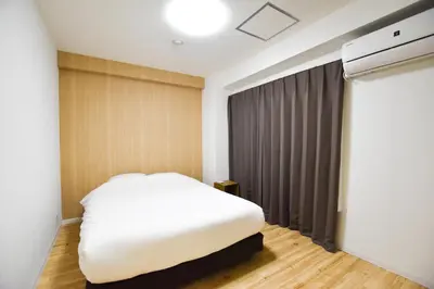 a bedroom with a white bed and a window at Randor Residence Tokyo Suites in Tokyo