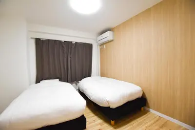 a room with two beds and a window in it at Randor Residence Tokyo Suites in Tokyo