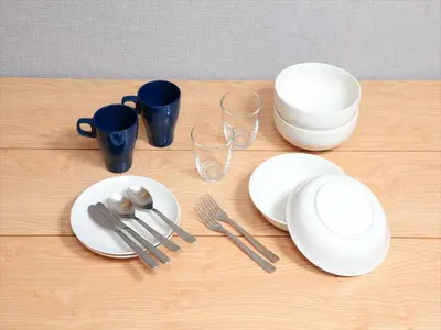 a table with white plates and utensils on it at COTO Tokyo Shibuya 2 in Tokyo