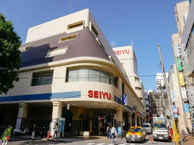 a building with a sign on it on a city street at COTO Tokyo Shibuya 2 in Tokyo