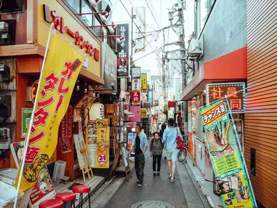 a group of people walking down a street at COTO Tokyo Shibuya 2 in Tokyo