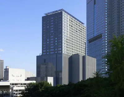 a tall glass building in a large city at The Capitol Hotel Tokyu in Tokyo