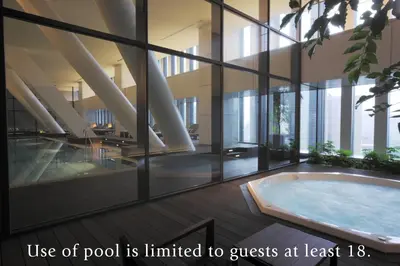a room with a hot tub in a building at The Capitol Hotel Tokyu in Tokyo