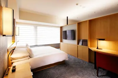 a hotel room with a bed and a desk at The Capitol Hotel Tokyu in Tokyo