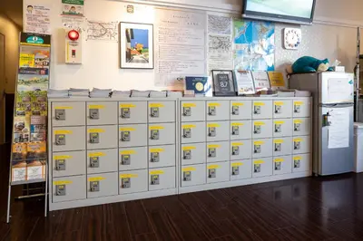 a bunch of lockers in a room with a wall at Hotel Owl Tokyo Nippori in Tokyo