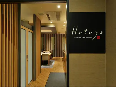 a hallway of a hotel with a sign on a wall at Dormy Inn Akihabara in Tokyo