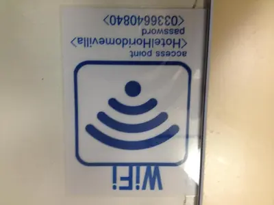a sign for a toilet in a bathroom at Hotel Horidome Villa in Tokyo