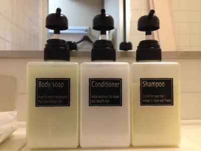 three bottles of soap sitting on top of a counter at Hotel Horidome Villa in Tokyo