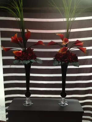 two vases with flowers in them on a table at Hotel Horidome Villa in Tokyo