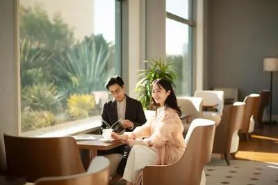 a man and a woman sitting at a table at Grand Nikko Tokyo Daiba in Tokyo