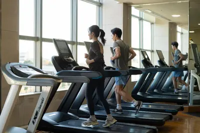 a group of people running on treadmills in a gym at Grand Nikko Tokyo Daiba in Tokyo
