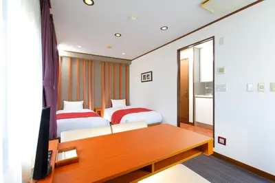 a hotel room with two beds and a desk at HOTEL MYSTAYS Kameido in Tokyo