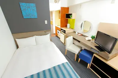 a hotel room with a bed and a desk at HOTEL MYSTAYS Ueno Inaricho in Tokyo