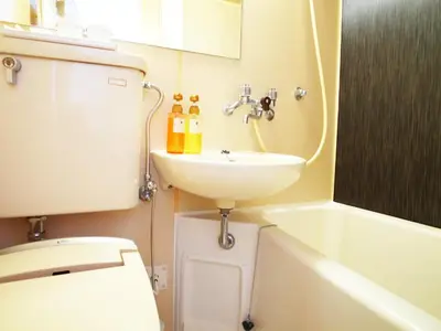 a bathroom with a sink and a toilet at HOTEL MYSTAYS Ueno Inaricho in Tokyo
