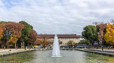 a fountain in a pond in front of a building at HOTEL MYSTAYS Ueno Inaricho in Tokyo