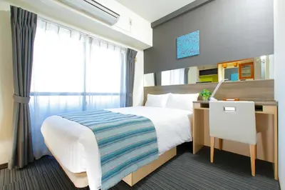 a hotel room with a bed and a desk at HOTEL MYSTAYS Ueno Inaricho in Tokyo