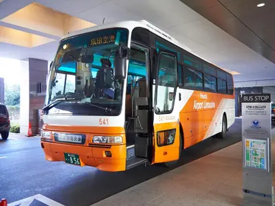 an orange and white bus parked in a building at Sotetsu Grand Fresa Tokyo-Bay Ariake in Tokyo