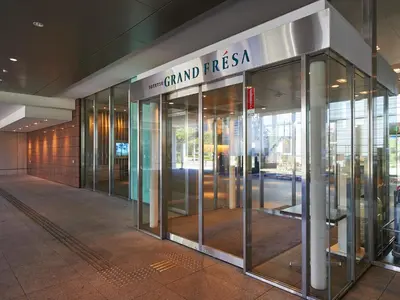 an entrance to a building with revolving glass doors at Sotetsu Grand Fresa Tokyo-Bay Ariake in Tokyo