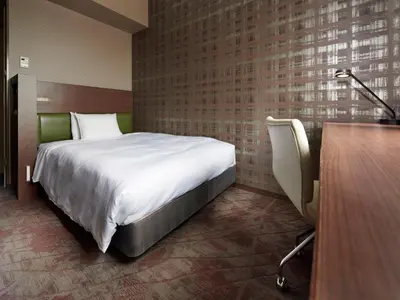 a hotel room with a bed and a desk at Sotetsu Grand Fresa Tokyo-Bay Ariake in Tokyo