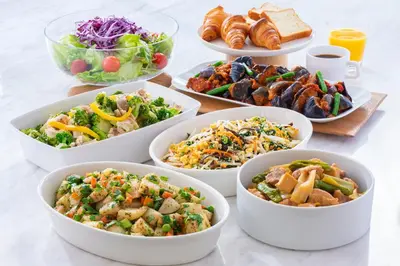 a table topped with bowls of different types of food at Candeo Hotels Tokyo Roppongi in Tokyo