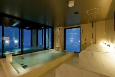 a bathroom with a large tub with a large window at Candeo Hotels Tokyo Roppongi in Tokyo