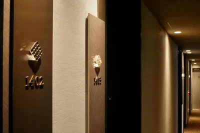 a door with a sign on the side of a building at Candeo Hotels Tokyo Roppongi in Tokyo