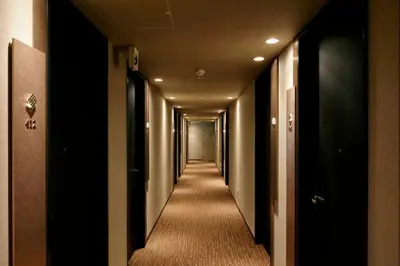 a hallway of a hotel with a long corridor at Candeo Hotels Tokyo Roppongi in Tokyo