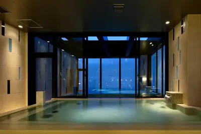 a swimming pool in a building with a view at Candeo Hotels Tokyo Roppongi in Tokyo