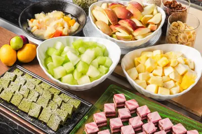 a table topped with bowls of different types of food at Hotel Sunroute Plaza Shinjuku in Tokyo