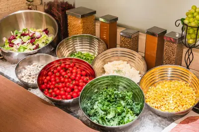 a bunch of bowls of food on a table at Hotel Sunroute Plaza Shinjuku in Tokyo