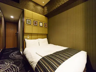 a bedroom with a large bed in a room at Sotetsu Fresa Inn Higashi Shinjuku in Tokyo