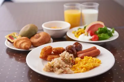 three plates of breakfast food on a table at Sotetsu Fresa Inn Higashi Shinjuku in Tokyo