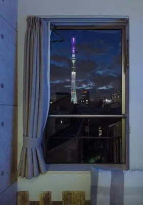 a window with a view of the eiffel tower at Tokyo Sakura hotel in Tokyo