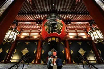 people walking up the stairs in a building with a large red chineseyrinth at Tokyo Sakura hotel in Tokyo