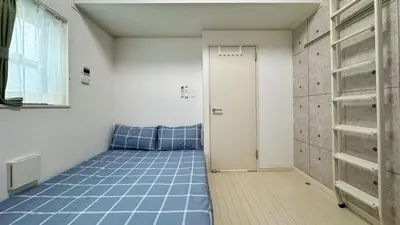 a room with a bed with blue tiles on the floor at Tokyo Sakura hotel in Tokyo
