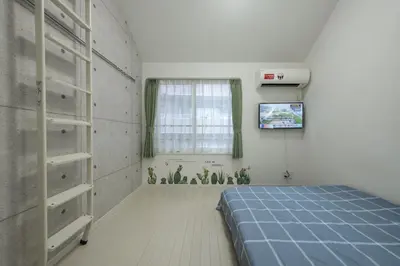 a bedroom with a blue bed and a window at Tokyo Sakura hotel in Tokyo