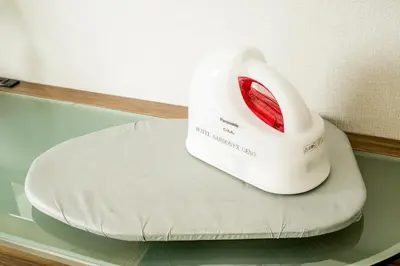 a white iron sitting on top of a pillow at Hotel Sardonyx Ueno in Tokyo
