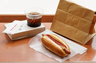 a hot dog sitting on a table next to a drink at Hotel Sardonyx Ueno in Tokyo