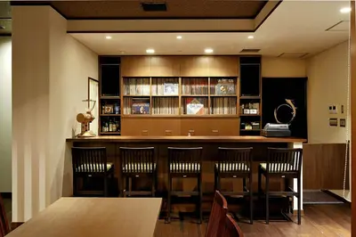 a bar in a restaurant with a table and chairs at Ochanomizu Hotel Shoryukan in Tokyo