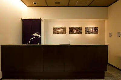 a room with three pieces of art on the wall at Ochanomizu Hotel Shoryukan in Tokyo